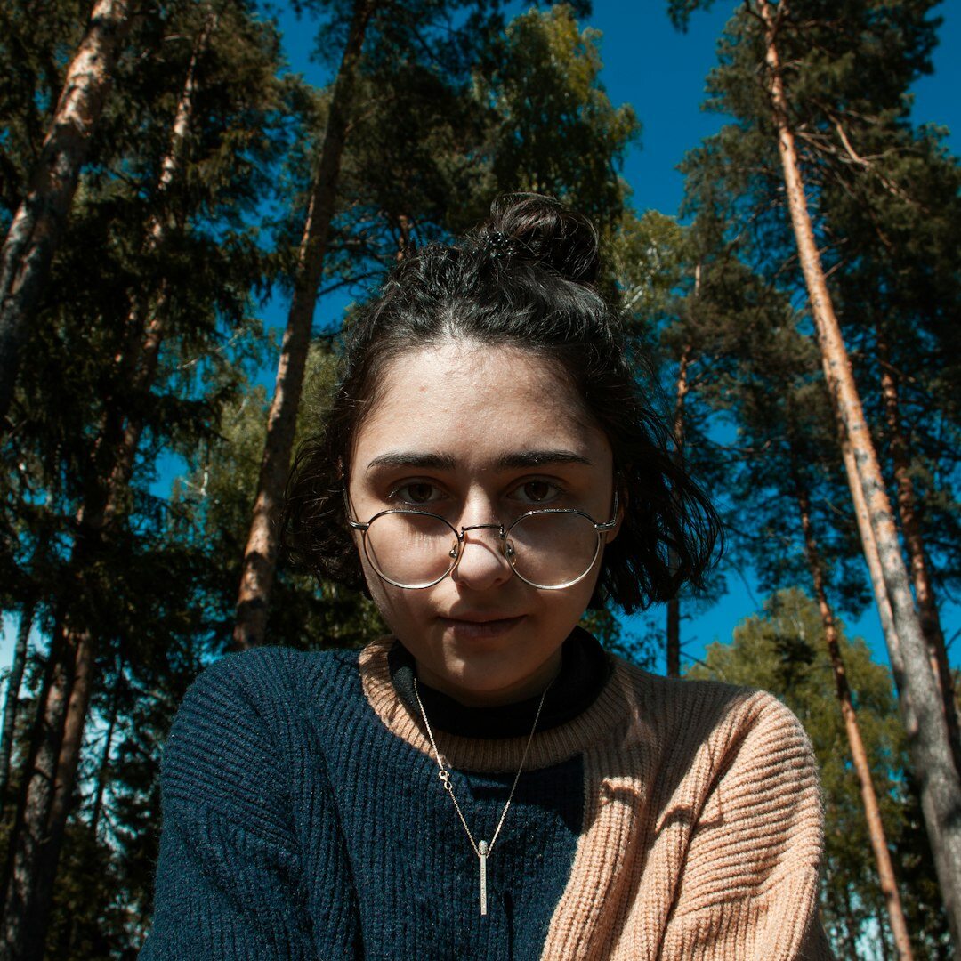Professional woman with glasses smiling confidently